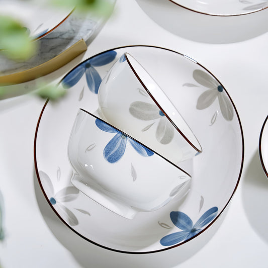 Ceramic plates with floral design on a white surface,