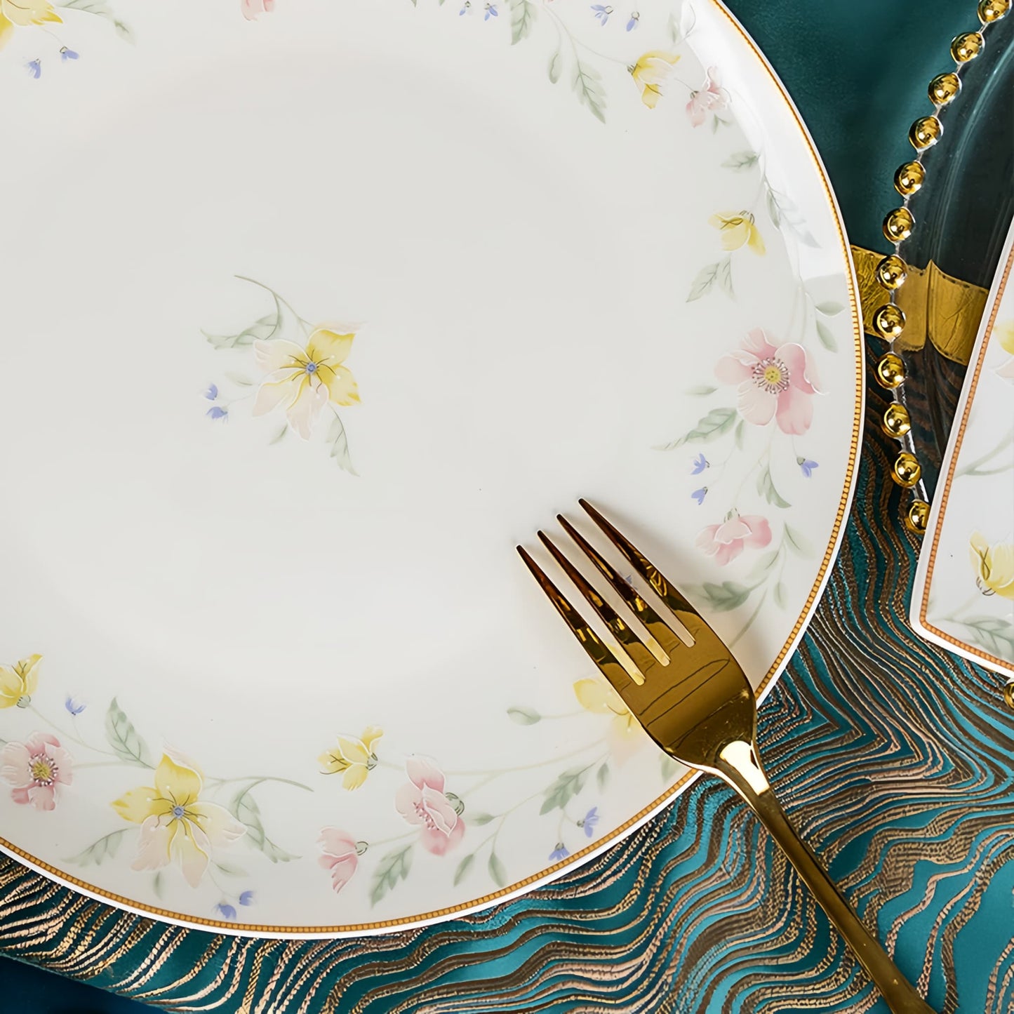 Floral-patterned plate with a gold fork on a decorative tablecloth, YUNGPING Spring Bloom Breeze Fine Bone China Dinnerware Set, Close-up detail