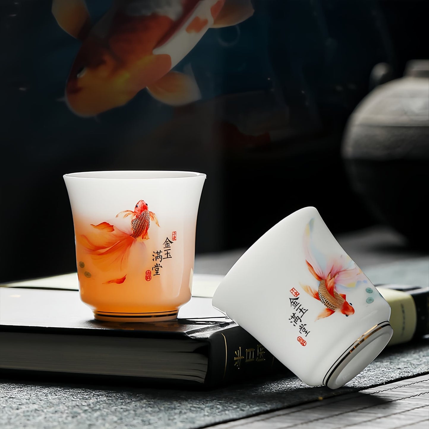Two ceramic cups with goldfish design on a dark surface,  YUNGPING Abundant Fortune Icy Jade Porcelain Kunfu Tea Set, 10-Piece