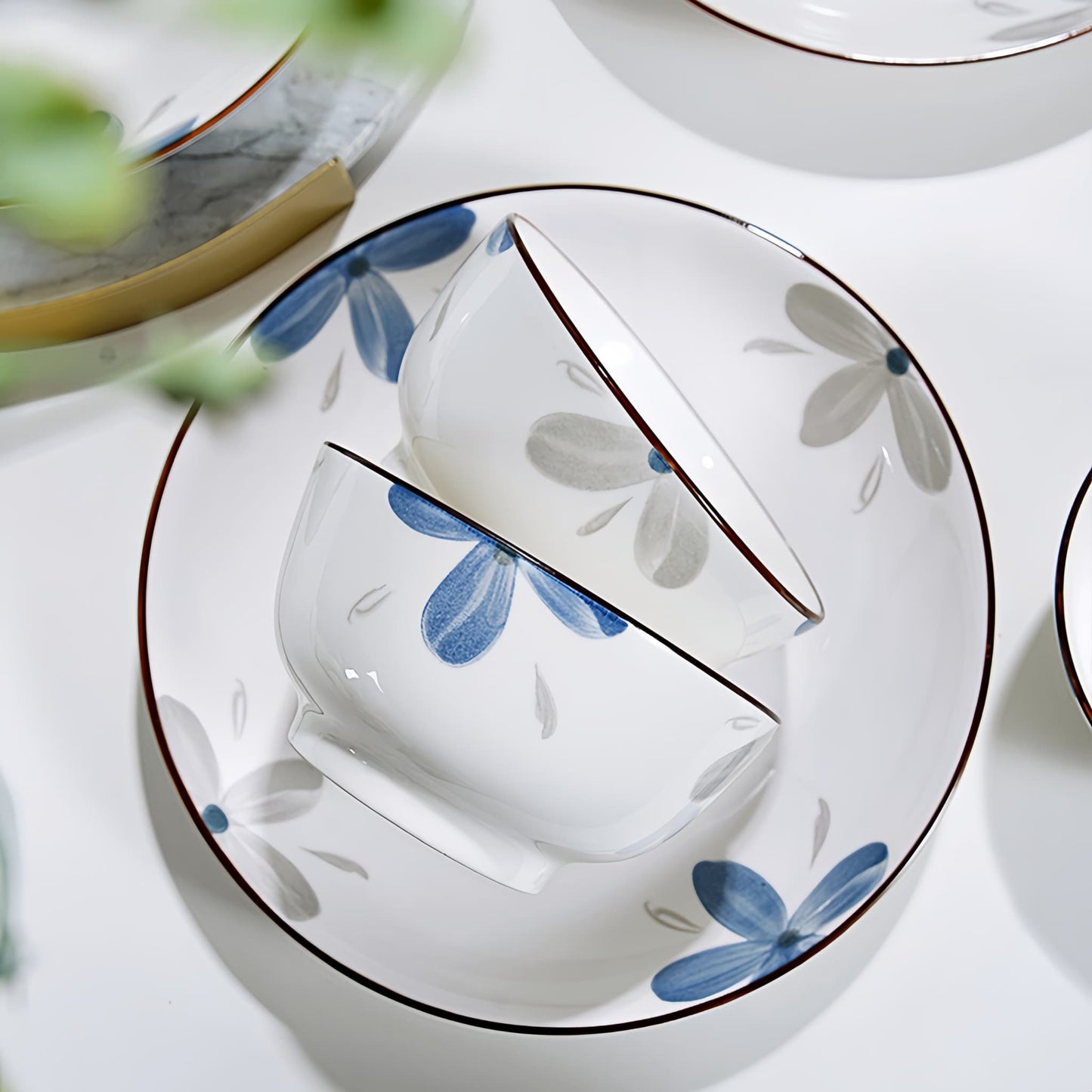 Ceramic plates with floral design on a white surface, 