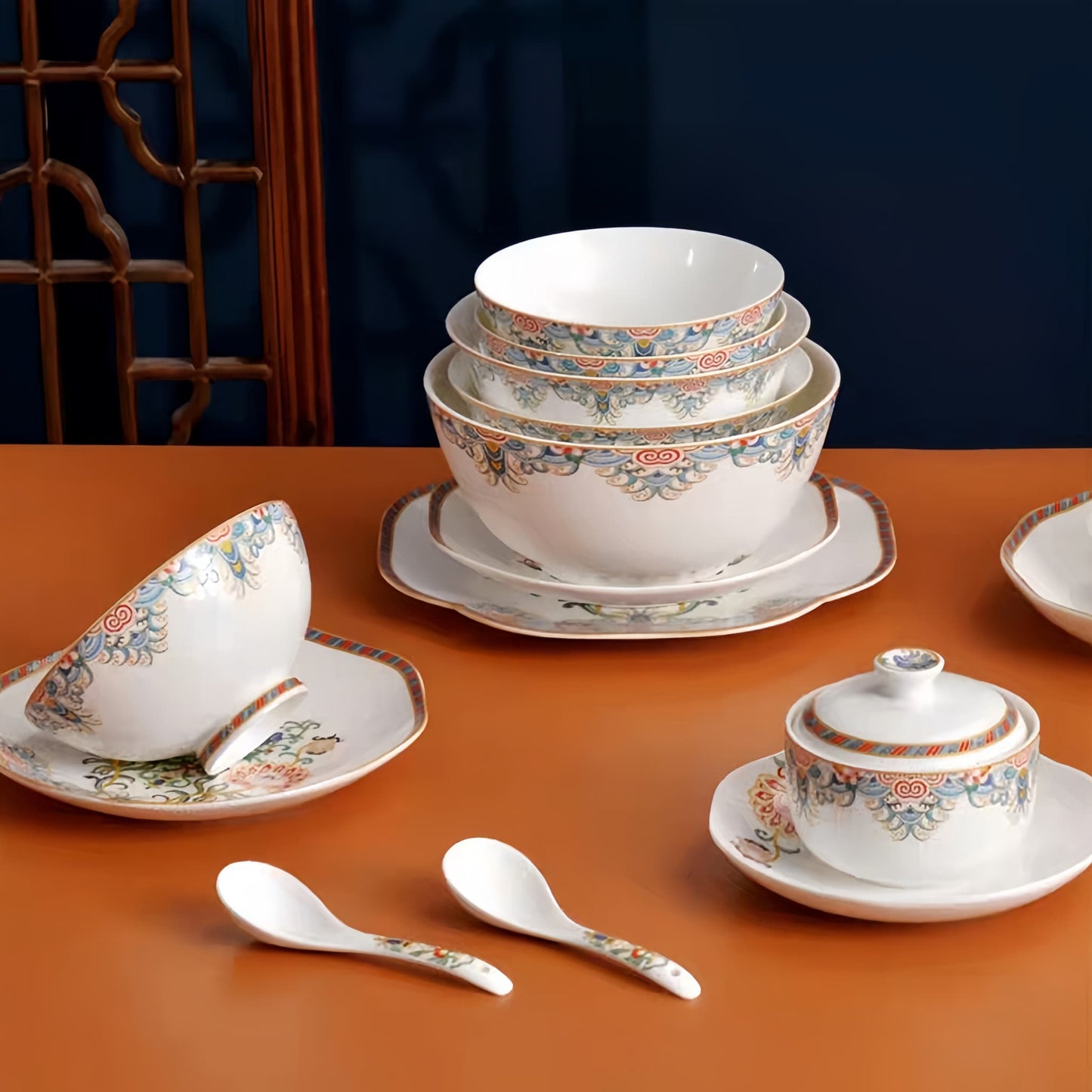 Set of  bowls, cups, and spoons with floral patterns on a brown surface. YUNGPING Brocade Floral Cluster Fine Bone China Dinnerware Set, Close-up detail