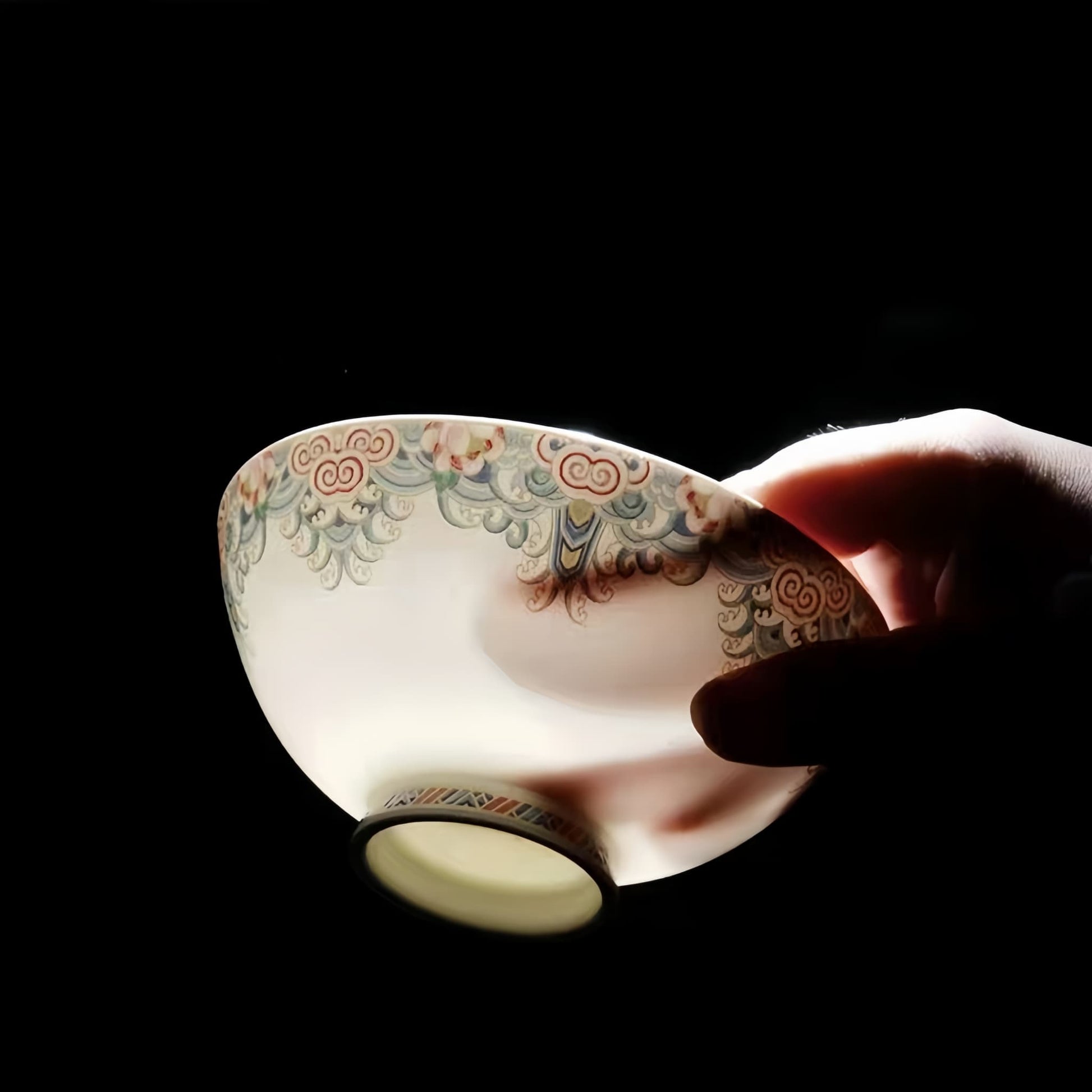 A close-up of YUNGPING Splendid Bouquet bone china product against light to display exceptional translucency and 45% bone ash content