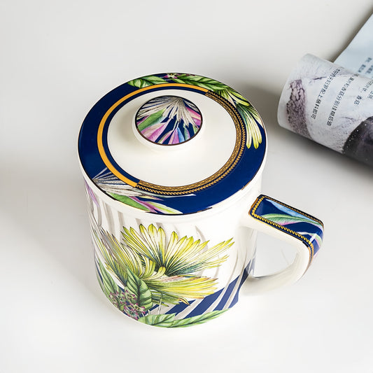 Decorative mug with floral design and colorful lid on a white surface, YUNGPING Jungle Sketch Fine Bone China Infuser Tea-Mug, 3-Piece, styled for a casual afternoon tea.