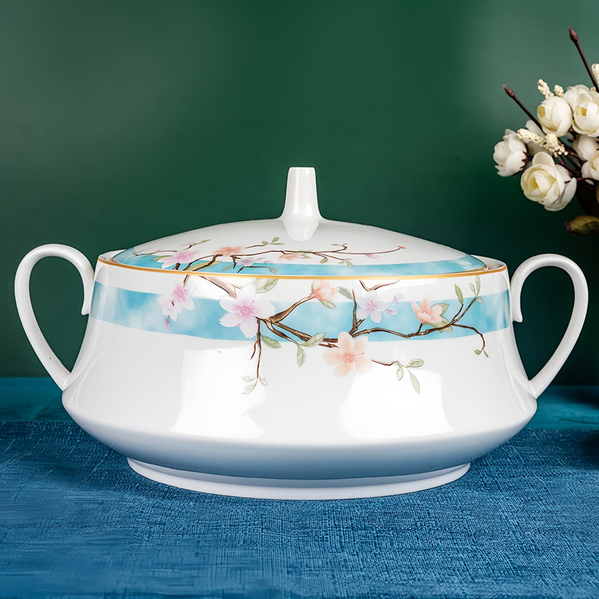 Decorative teapot with floral design on a blue surface, YUNGPING Peach Blossom Veil2 Fine Bone China Dinnerware Set, Close-up detail